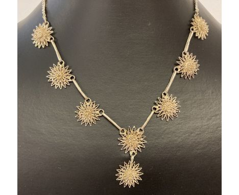 A vintage silver necklace with filigree flower detail and hoop and eye style clasp.  Marked 925 to clasp. 