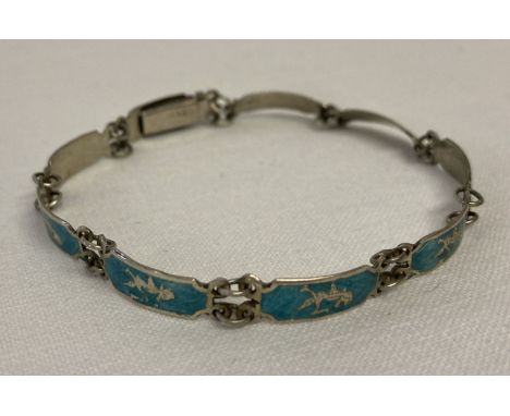 A vintage silver and enamel small panel bracelet decorated with Thai dancers. Push clasp.  Worn silver marks to clasp. 