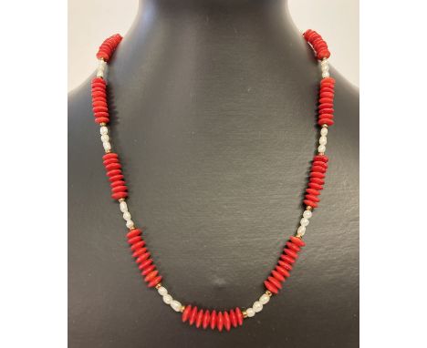 An 18" bamboo coral and fresh water pearl necklace with gold coloured T bar clasp.  