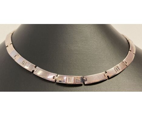 A modern design silver torque style necklace with clear stone decoration to 3 links.  Push clasp with safety clip. 925, scale