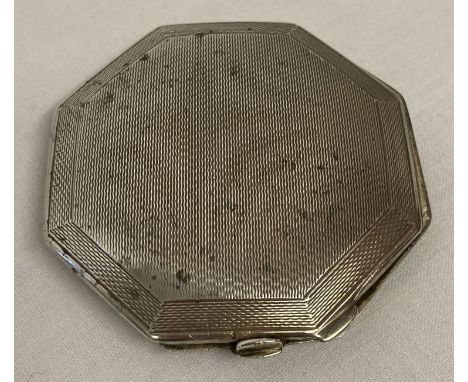 An octagonal silver compact with engine turned decoration front and back.  Hallmarked Birmingham 1947. With internal mirror. 