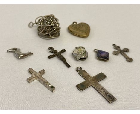 9 vintage and modern silver and white metal pendants.  To include a sterling and gold filled heart locket, 3 silver crosses a