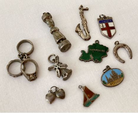 10 vintage silver and white charms.  To include: a Ju-Ju figure, a saxophone and an enamelled yacht. 