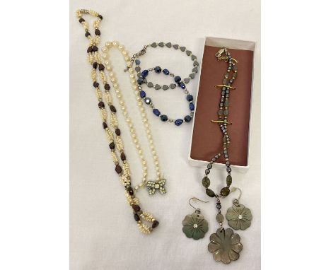 4 items of pearl jewellery. A vintage pearl necklace, a peacock potato pearl  and hematite stretch bracelet, a garnet chip an