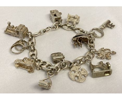 A vintage mariner style silver charm bracelet with 12 silver and white metal charms. Spring clasp to bracelet. Charms Compris