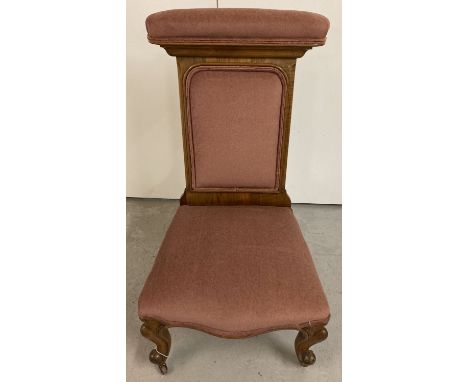 A Victorian Prie Dieu chair with turned cabriole style legs and ceramic castors.  Covered with dusky pink velvet upholstery. 