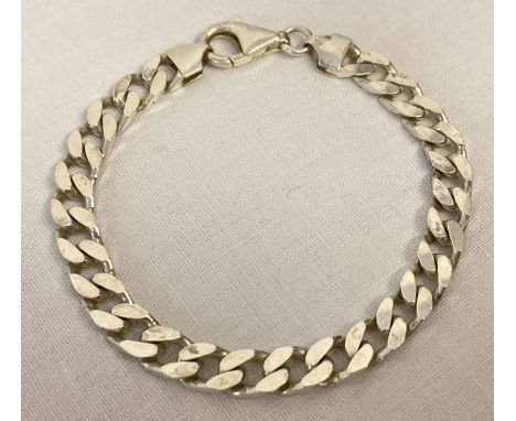 A silver curb chain bracelet with lobster style clasp.  Fixings and clasp marked 925 with scales mark and makers initials.  T