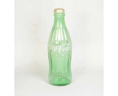 Huge glass Coca-Cola bottleHuge Coca-Cola bottle made out of light green glass with a plastic cap. Plastic cap can be removed