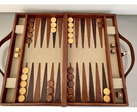 BACKGAMMON SET, in leather case, 7cm x 23cm x 40cm. 