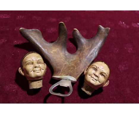 Two novelty ceramic bottle stoppers and a horn bottle opener 