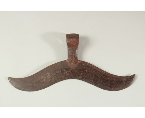 A LARGE 17TH -18TH CENTURY SOUTH INDIAN AXE HEAD, engraved and with traces of red pigment. 32cm long.