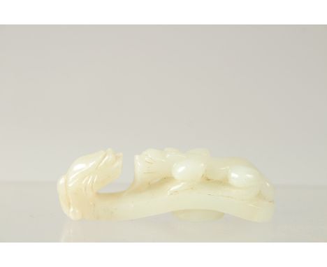 A FINE 19TH-20TH CENTURY QING DYNASTY CARVED WHITE JADE BELT HOOK, 6.5cm long.