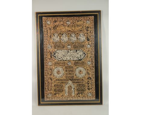 A LARGE 20TH CENTURY ISLAMIC GILT METALLIC THREADED TEXTILE CALLIGRAPHY MOSQUE PANEL, framed and glazed, 104cm x 79cm overall