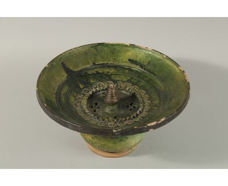 A RARE 17TH-18TH CENTURY PERSIAN SAFAVID GREEN GLAZED POTTERY WASHING BASIN, 29cm diameter.