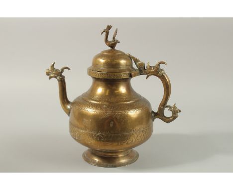 AN 18TH -19TH CENTURY MUGHAL INDIAN ENGRAVED BRASS EWER, with dragon shape handle and spout, peacock shaped finial, and finel