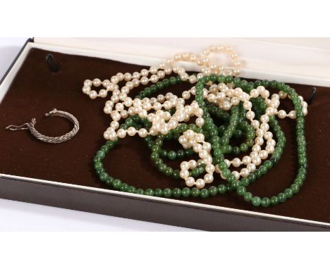 A pearl necklace, a green stone necklace and a single white metal earring. Encased in a box.Gross weight 48.5 grams.