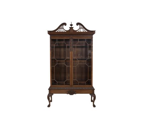 A GEORGIAN STYLE MAHOGANY TWO DOOR DISPLAY CABINET, of rectangular form, surmounted by broken swan neck cornice, centred with