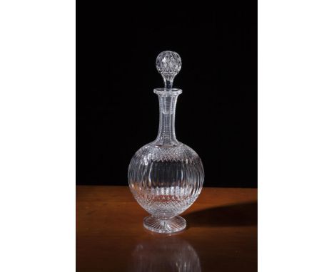 AN ENGLISH CUT-CRYSTAL OVAL BALUSTER DECANTER AND STOPPER, on pedestal foot