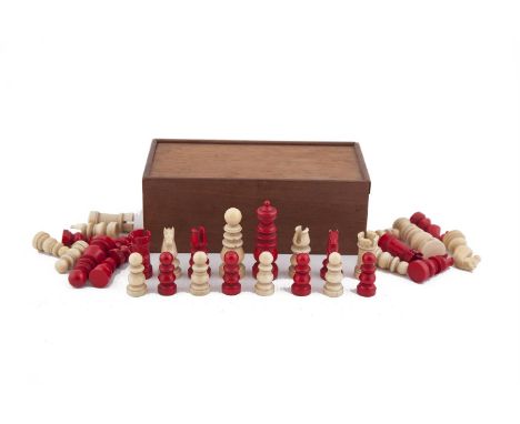 AN EARLY 19TH CENTURY ENGLISH IVORY CHESS SET, one side stained red, the other side left in natural white. The Kings 6.3cm hi