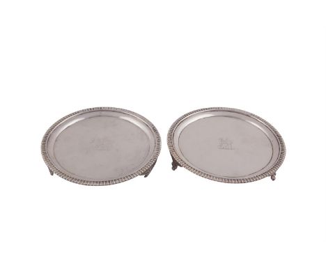 A PAIR OF GEORGE III SILVER CARD TRAYS, London 1806, mark of Naphthäli Hart, of circular form with beaded rim and raised on r