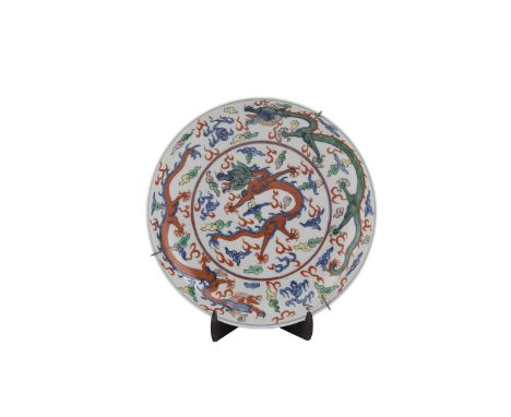 A CHINESE DOUCAI ENAMEL DRAGON DISH, 19th century, of circular form, painted and enamelled with dragons contesting the flamin