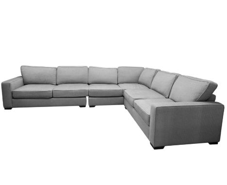 A LARGE TIMBER FRAMED UPHOLSTERED SECTIONAL 'L' SHAPED SOFA, in three pieces with loose back and seat cushions, covered in pi