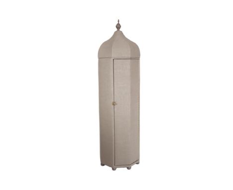 A TIMBER FRAMED UPHOLSTERED OCTAGONAL WARDROBE, covered in grey fabric, with removable domed top with spiral finial, fitted s