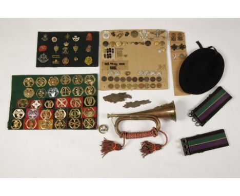A COLLECTION OF MILITARY CAP BADGES, including U.S., Canadian Regiment and others, a regimental bugle, cap and Military butto