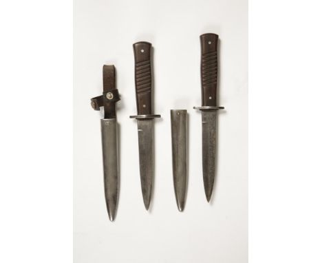 TWO FIRST WORLD WAR COMBAT KNIVES with scabbards and wooden grips (2)