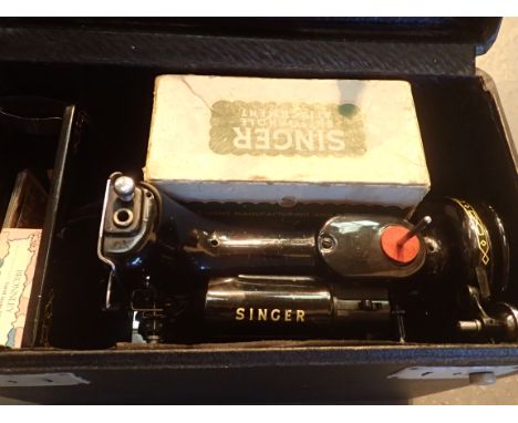 Singer electric sewing machine model 221K, with carry case and button hole attachment