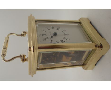 Brass carriage clock marked London Clock Company with key