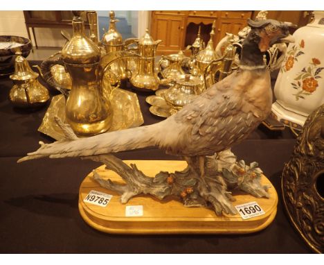 Large ceramic pheasant on a wooden plinth, L: 50 cm