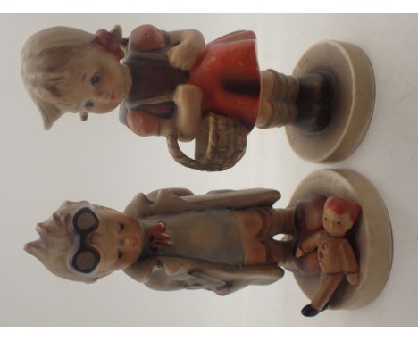 Two Goebel figurines of a boy and a girl