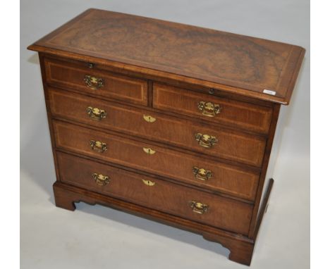 A 19th century burr walnut and feather banded bachelor's chest of 3 long and 2 short drawers, brushing slide and bracket feet
