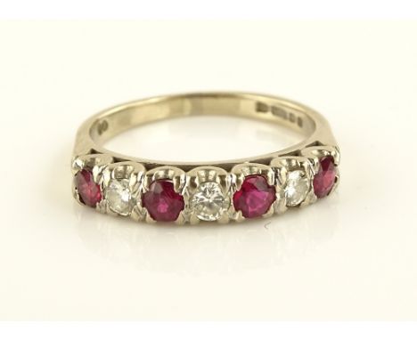 An 18ct gold 7 stone ruby and diamond ring, setting height 4mm, size O.