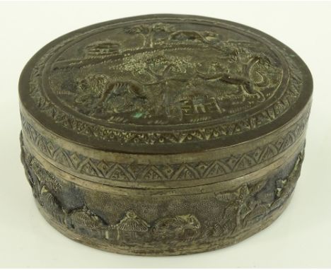 An Indian unmarked white metal oval box, relief embossed tiger hunting scenes, length 9cm.