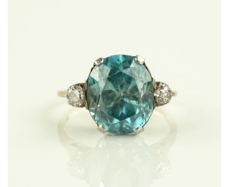 An unmarked gold 3 stone topaz and diamond set ring, topaz 6.36cts approx. setting height approx. 11mm, size M.