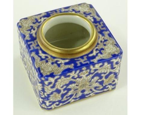 A Chinese porcelain inkwell, painted blue and gilt floral scroll designs, 4 character seal mark under, width 5.5cm.