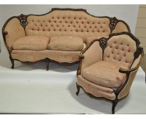 A Victorian walnut framed parlour sofa and matching armchair, with carved and pierced floral decorated surround, shaped friez