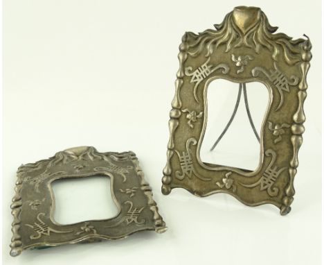 A pair of Chinese silver photo frames, relief embossed decoration with heart shaped pediments, height 18.5cm.