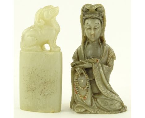 A Chinese carved soapstone seated deity, height 8.5cm and a carved hardstone dog of fo desk seal, (2).