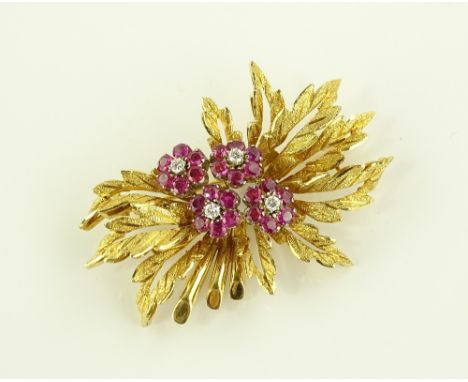 An 18ct gold ruby and diamond set flower brooch, brooch length 52.9mm, 18g.