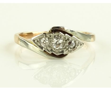 A 9ct gold platinum and 3 stone diamond crossover ring, size K.