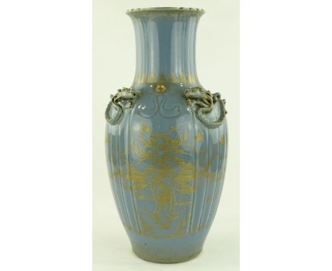 A large Chinese pale blue glazed porcelain vase, applied dragon decorated shoulders with painted gilded landscape designs, se