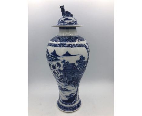 A Blue and White Oriental lidded vase with Foo Dog finial. 29cm.