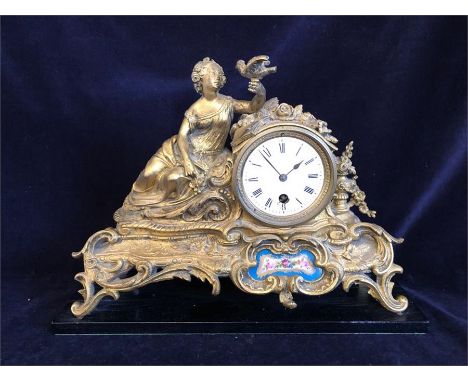 A Gilt metal clock with decorative enamel front plate