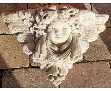 Stone garden ornament of a wall mounted Cherub's face plaque