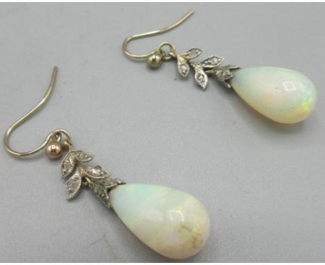Early 20th century yellow and white metal opal drop earrings, the foliage shaped mount set with diamonds, no hallmark 