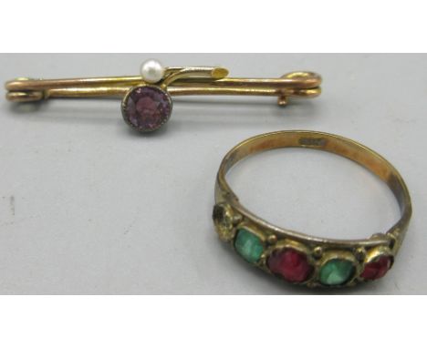 9ct yellow gold ring, set with green and red stones, one missing, stamped 9ct, and a 9ct gold bar brooch with applied 15ct de