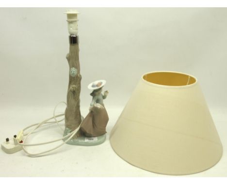 Nao Pottery lamp, modelled as a girl with a basket under a tree, with shade, H39.5cm 